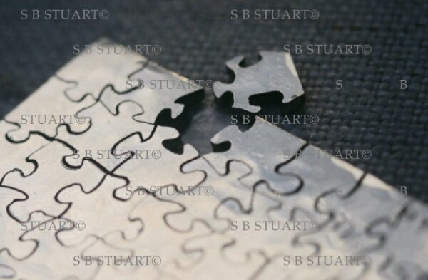 silver small hand cut jigsaw puzzle
